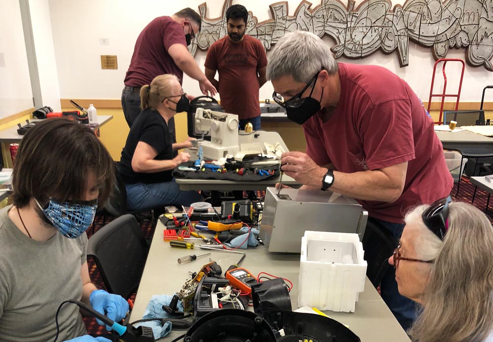 Fixers work on items at one of King County EcoConsumer's Repair events