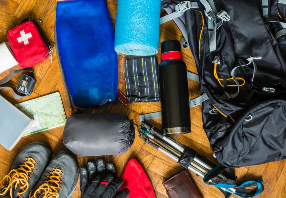 Outdoor gear lending services header - overhead image of hiking, camping, and outdoor gear