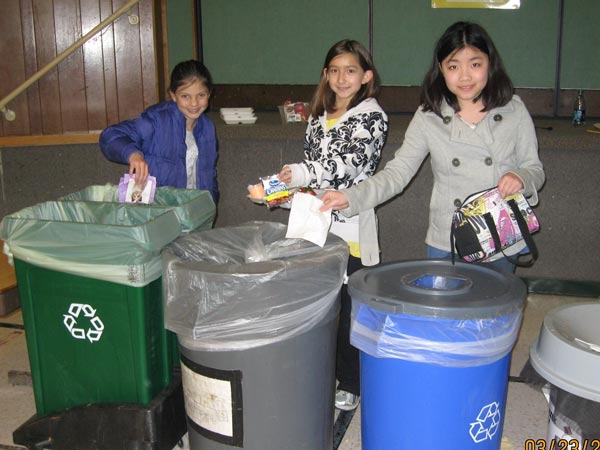 Students use the correct composting, recycling and garbage containers at lunch.