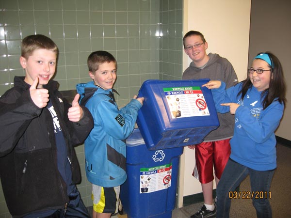 Enatai students take pride in emptying classroom recyclable materials into larger hallway bins.