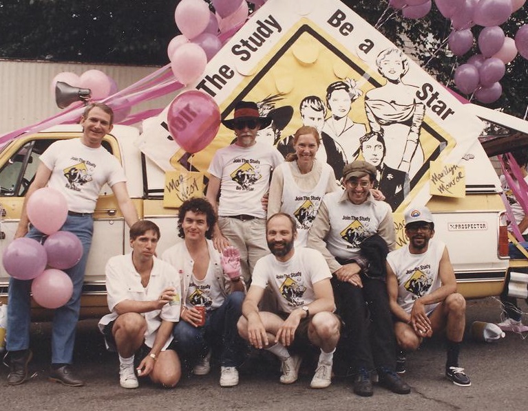 People in matching t-shirts standing in front of a parade float