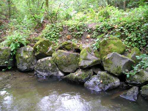 Photo of Miller Creek showing revetment constructed of large boulders