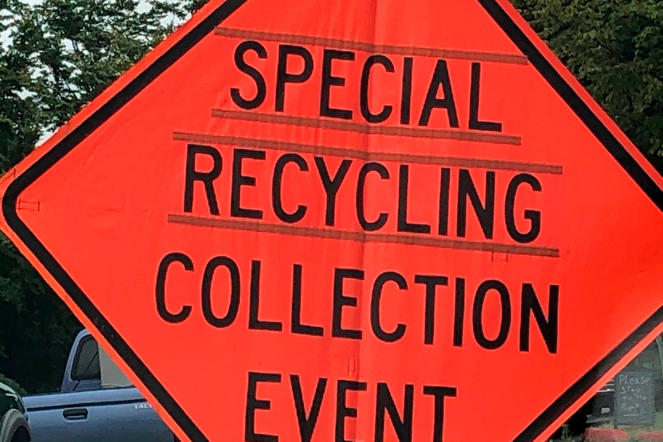 Orange road sign that reads "special recycling collection event"