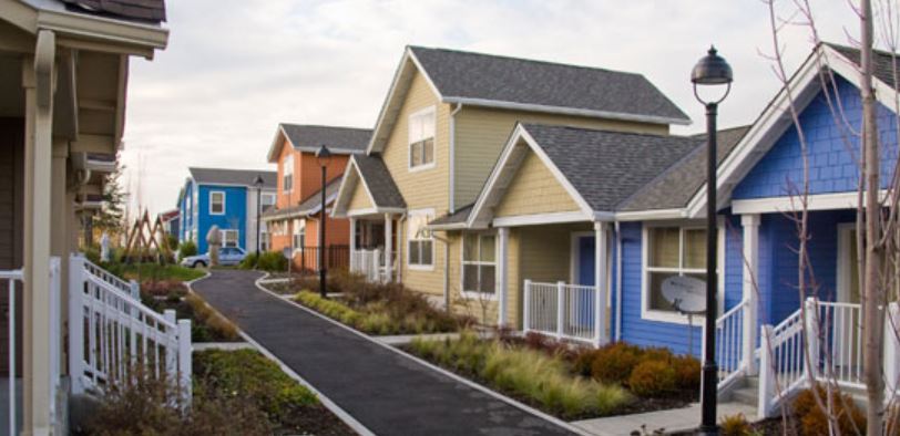 row of houses with a sidewalk