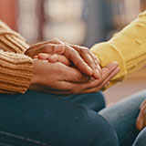 Caregiver holding hands.