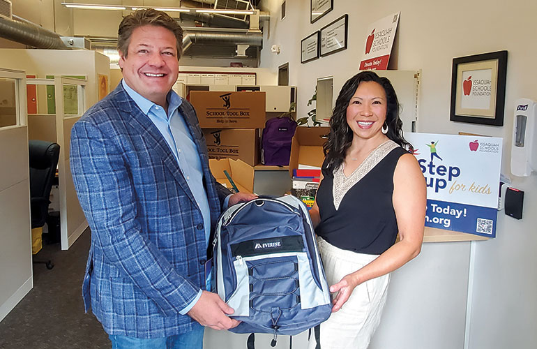 Councilmember Dunn with constituent holding a backpack.