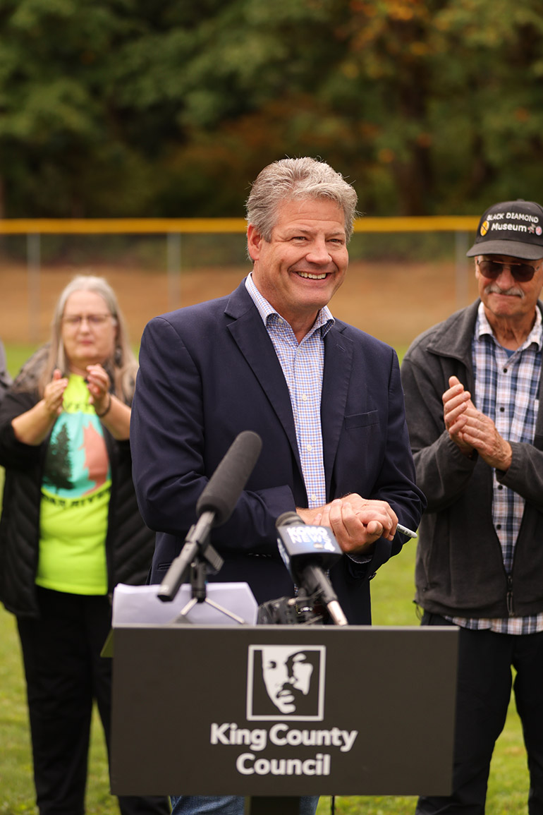 Photo of King County Councilmember Reagan Dunn smiling during a press conference.