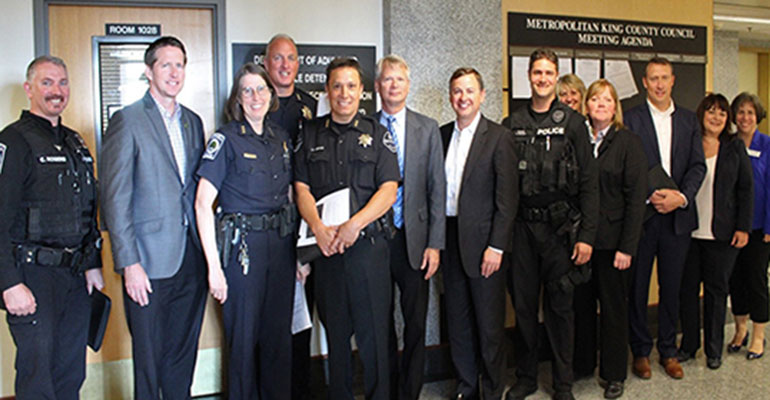 Group of 13 standing with Councilmember Dembowski.