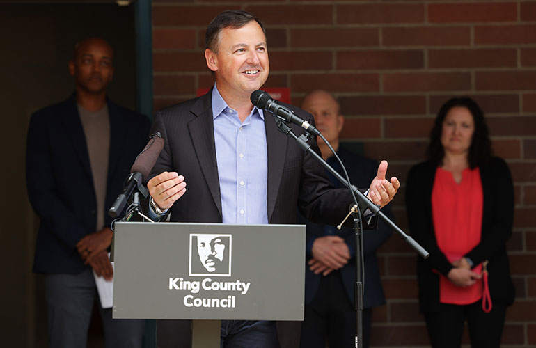 Councilmember Rod Dembowski speaking at senior women's shelter event in Kenmore.