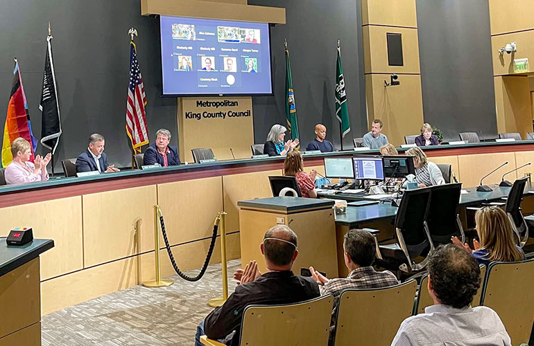 Overview of Council chambers with several councilmembers and audience members in attendance.