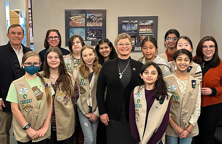 Councilmembers Sarah Perry and Pete von Reichbauer pose with Girl Scout troop.