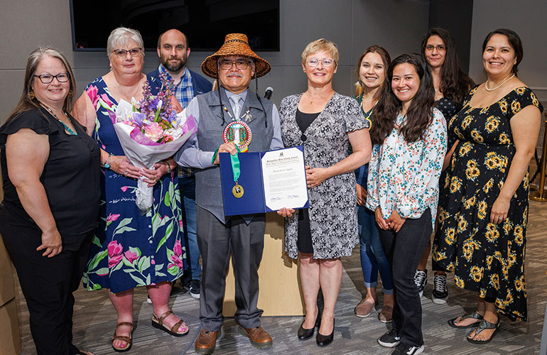 Councilmember Perry with Tribal Chairman Robert de los Angeles and community members as he receives the MLK award.