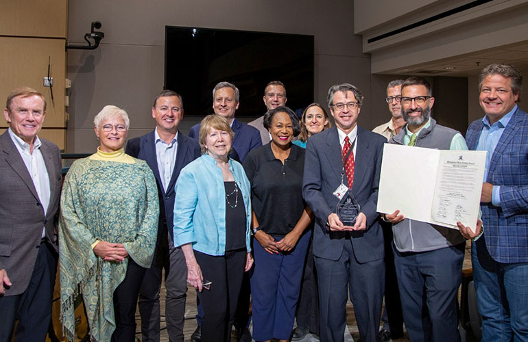 Councilmembers pose with David Coffey and others.