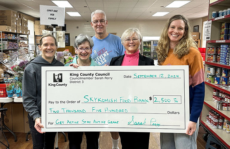 Group holding a large check for $2500.