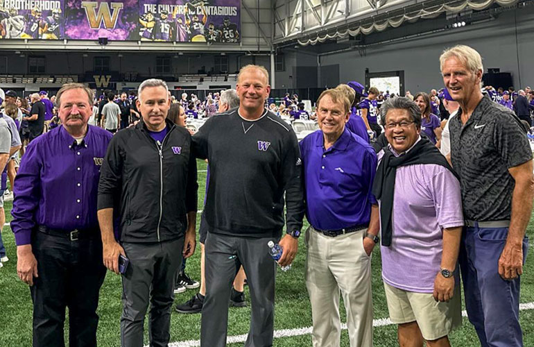 Councilmember von Reichbauer standing with 5 others at the Dempsey Indoor Practice Facility during the UW Raise the Woof event.
