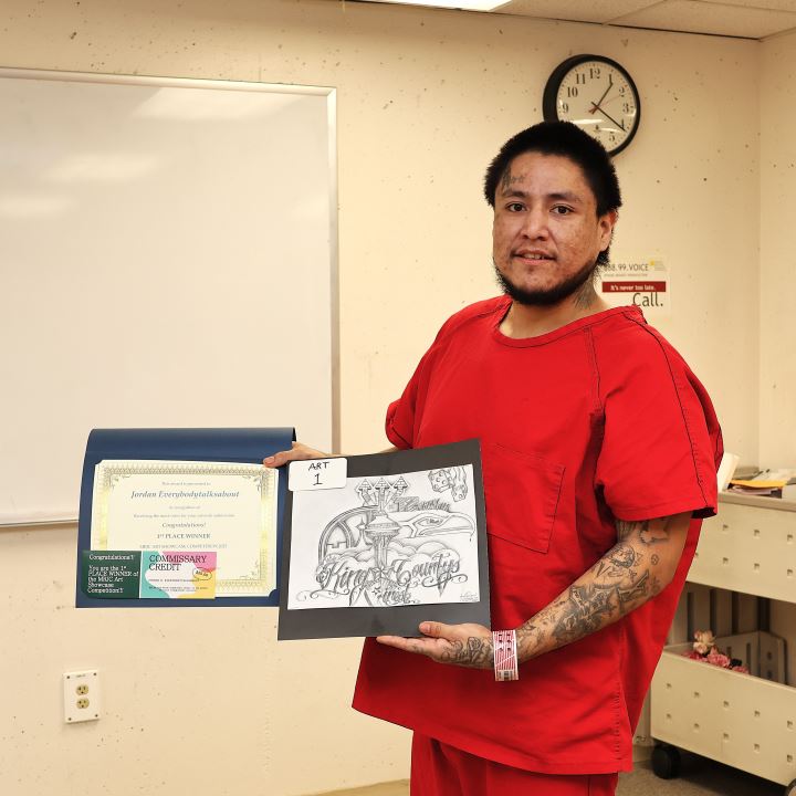 Jordan Everybodytalksabout, a resident at the Maleng Regional Justice Center, showcases his winning submission in a spring-themed art contest.