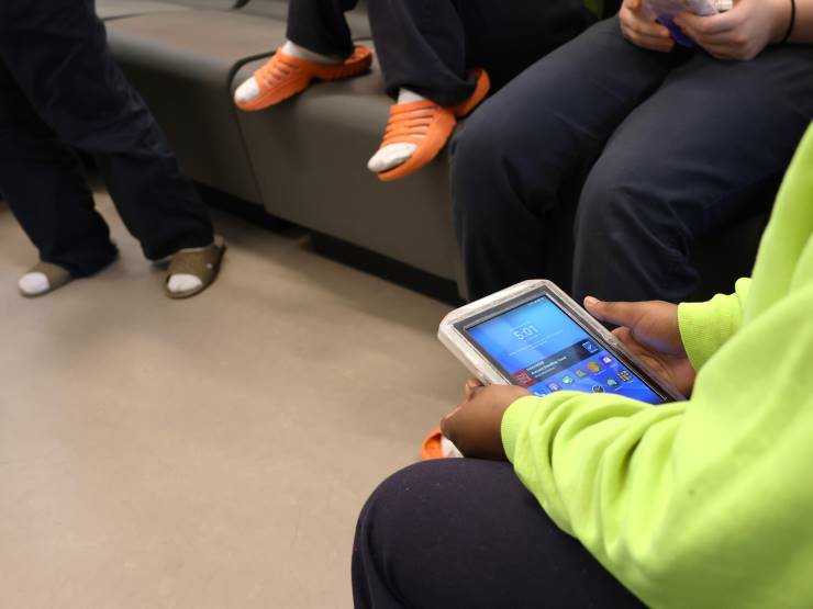 Youths at the Clark Children and Family Justice Center use computer tablets in March 2024.