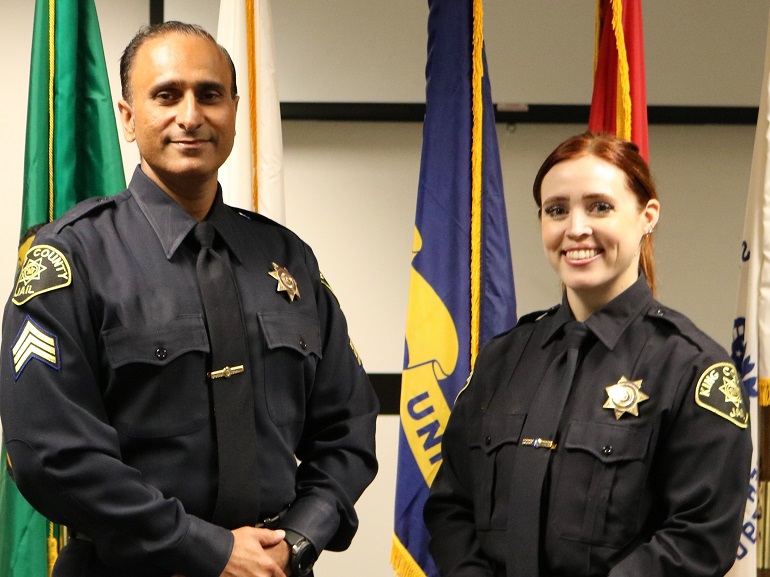 A male King County Corrections Sergeant and a female King County Corrections Sergeant pose for a photo at the Maleng Regional Justice Center in Kent.