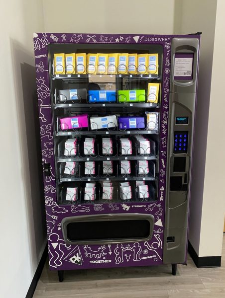 Image of a harm reduction vending machine which has a flower bouquet on the side and the words naloxone saves lives.