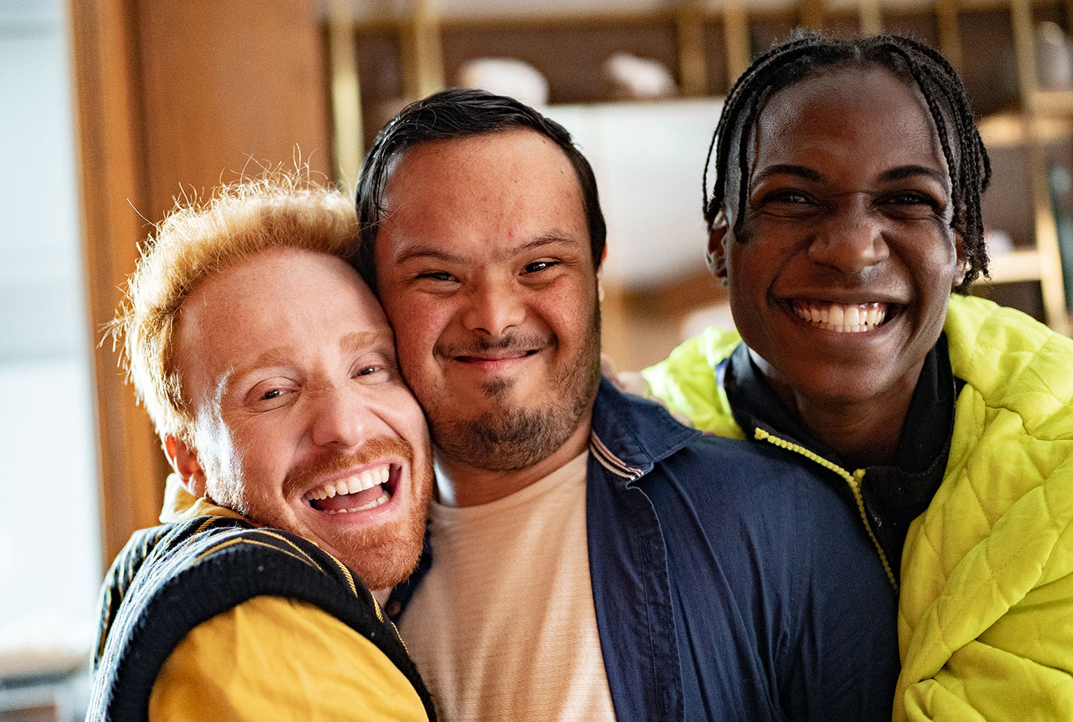 Three adults hugging