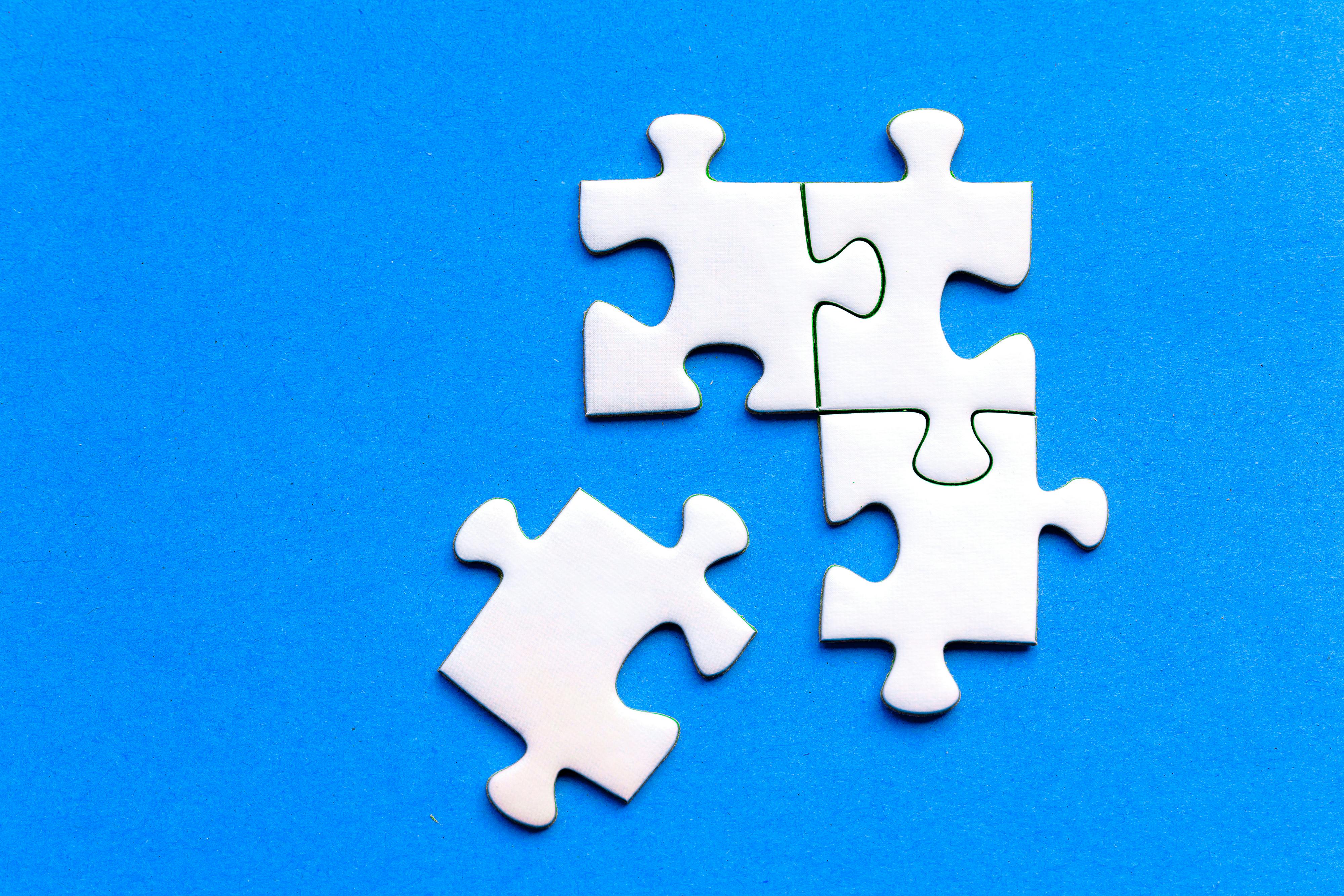 a blue background with 4 white puzzle pieces
