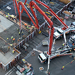 Aerial photo of pump trucks pouring concrete at West Point Treatment Plant