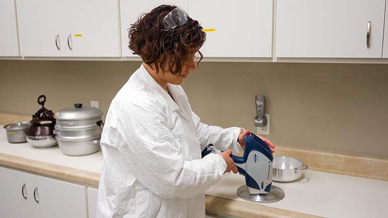 Dr. Katie Fellows, a King County Environmental Scientist, uses a handheld X-Ray Fluorescence (XRF) analyzer to test for lead in aluminum cookware