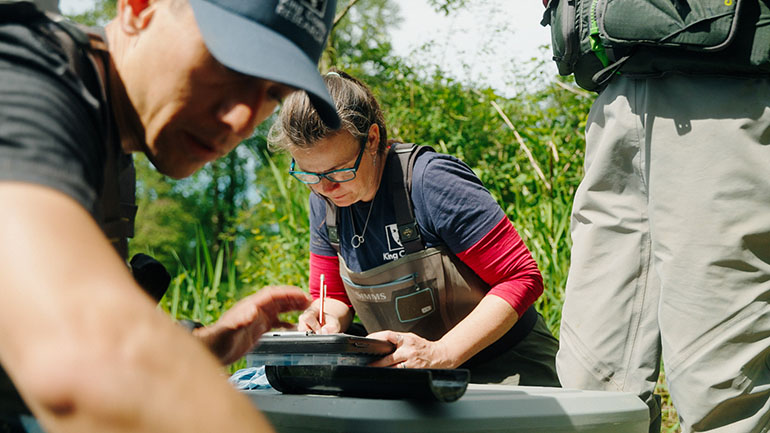 Scientists documenting findings from research on a salmon habitat restoration project