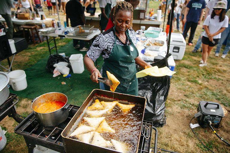 Woman tending a deep fryer at Chomp