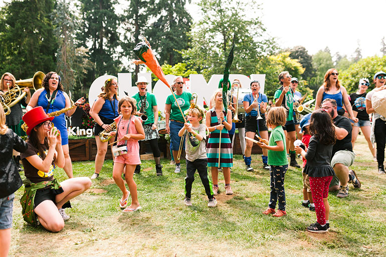 People having fun making music at Chomp including many children.