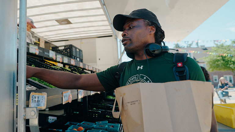 Man working at the Farestart mobile food pantry