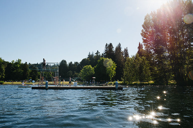 Sunny swimming area on Lake Washington with a platform and diving boards
