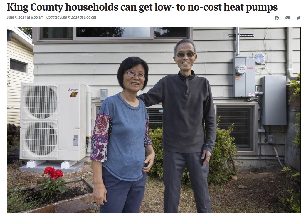 photo of couple smiling near a heat pump