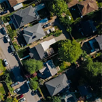 Aerial view of rooftops and trees in a neighborhood of single family homes