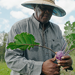 Snoqualmie River farmer holding kohlrabi