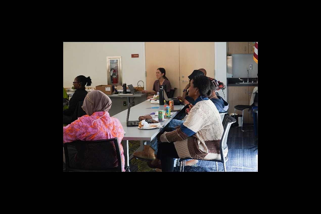 several people listen to a presentation