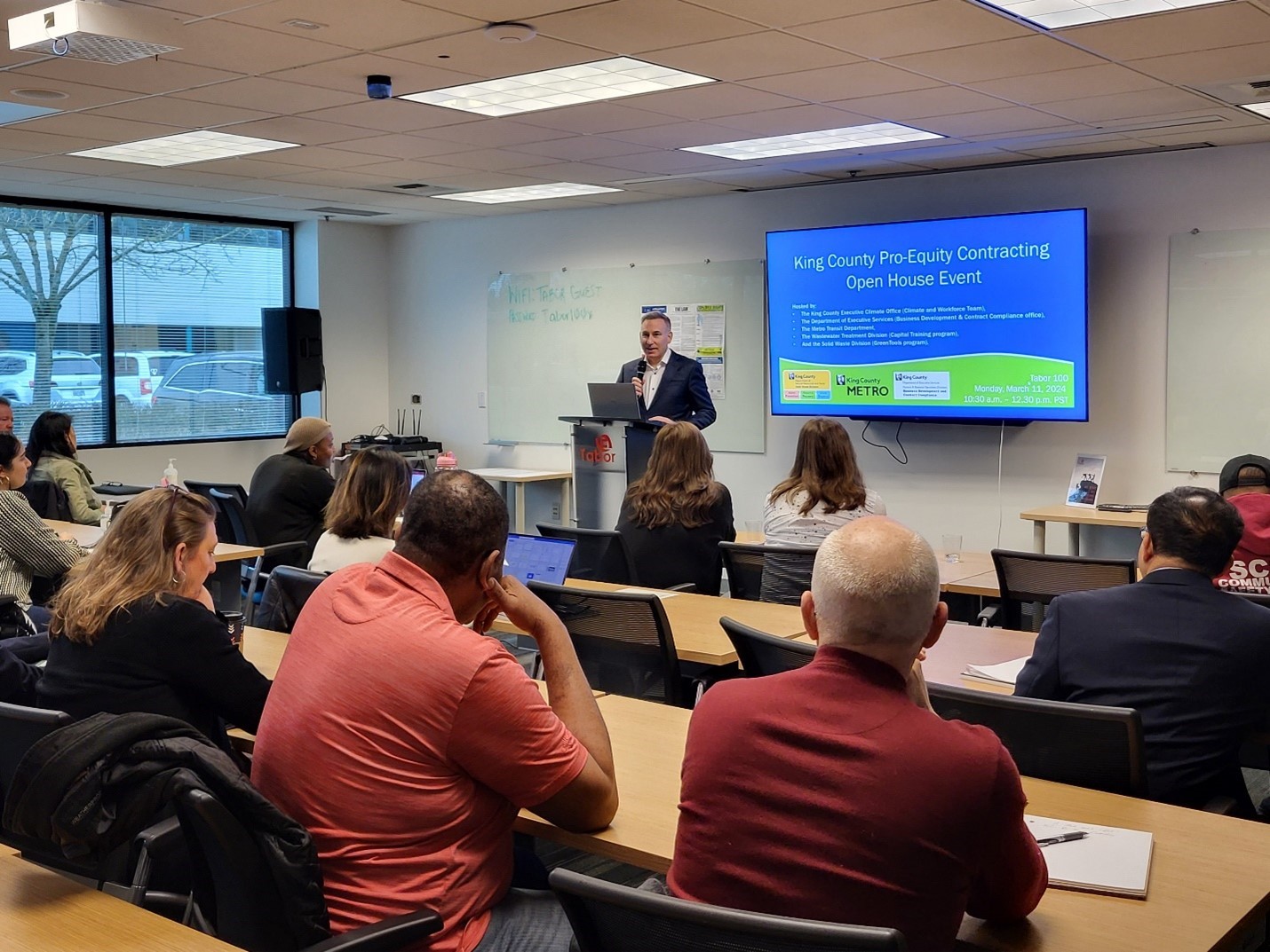 man speaking to classroom full of people