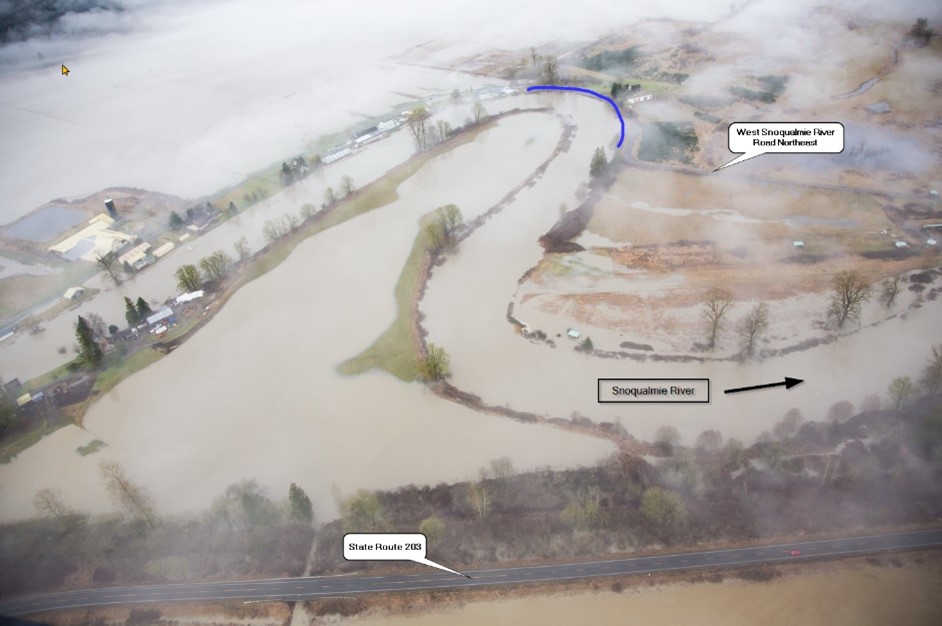 Aerial photo of floodwater covering a portion of a valley.