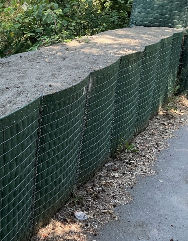 Temporary flood barriers with sand in Roegner Park.