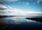 Lake Washington under a blue sky with distant white clouds.