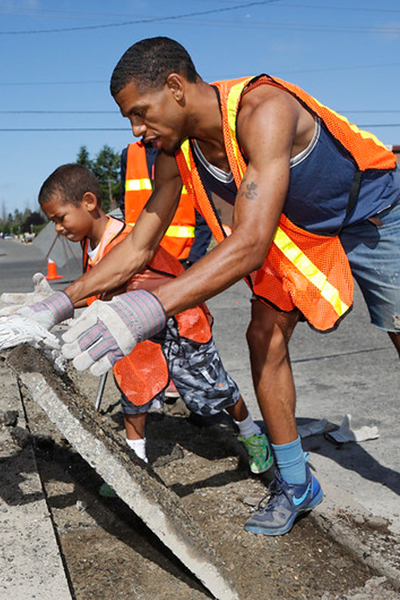 A family removes unnecessary pavement that will be replaced with water-friendly alternatives.