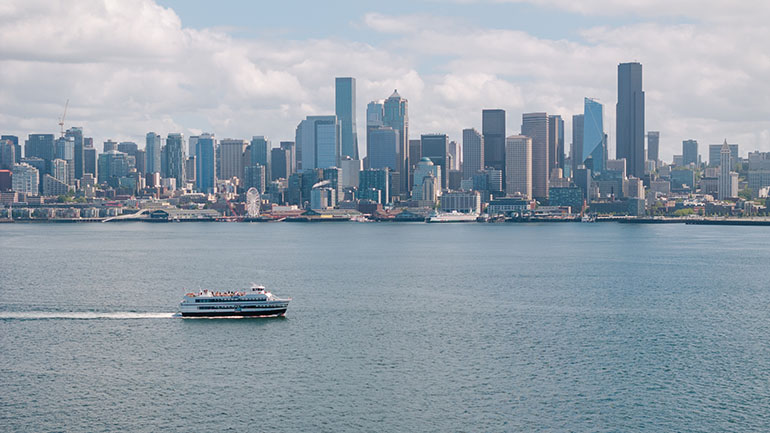 Elliott Bay with passenger ferry and the buildings of downtown Seattle 