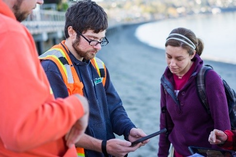 A man and a woman looking at an iPad.