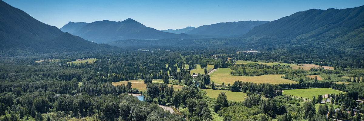 A landscape shot showing the Snoqualmie River and the Cascade foothills
