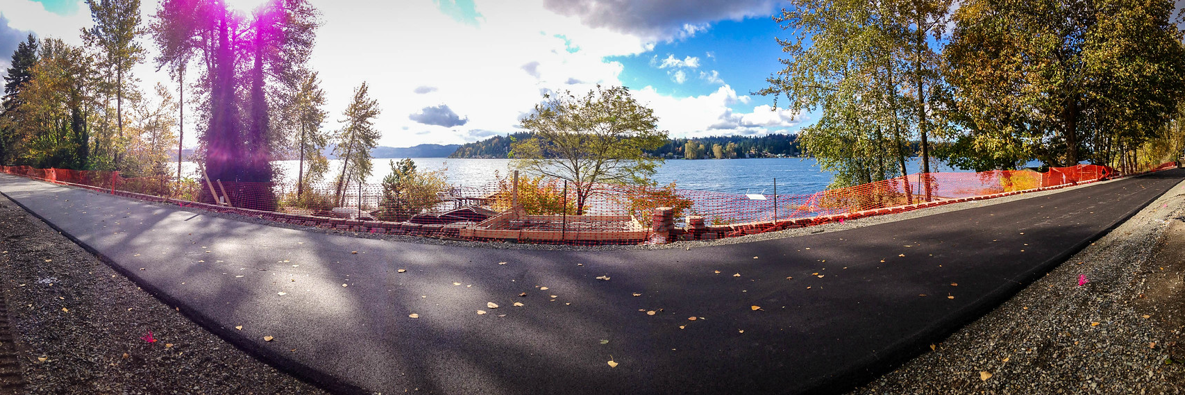Fish eye lens shot of a partially constructed East Lake Sammamish Trail with the lake in the background