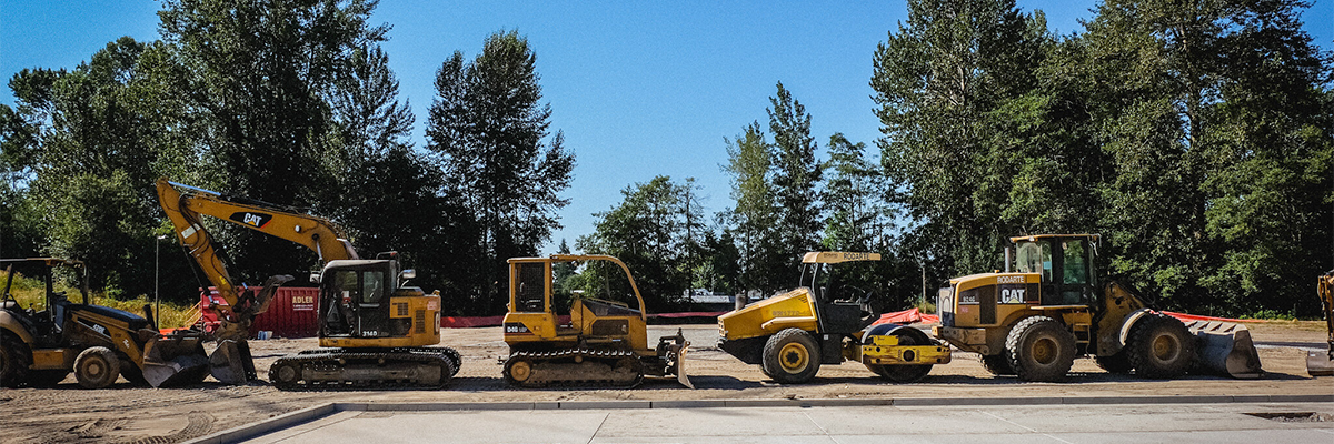 A line of heavy construction equipment at Skyway park