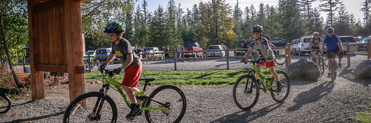 A couple of kids on mountain bikes at Black Diamond Open Space trailhead