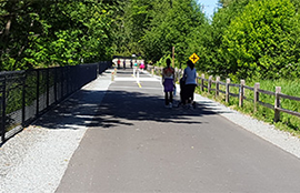 Two people travel down a section of the East Lake Sammamish Trail