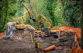 Two backhoes work on the corridor for the Foothills Trail