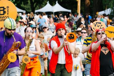 A large group of people play horns at King County CHOMP!